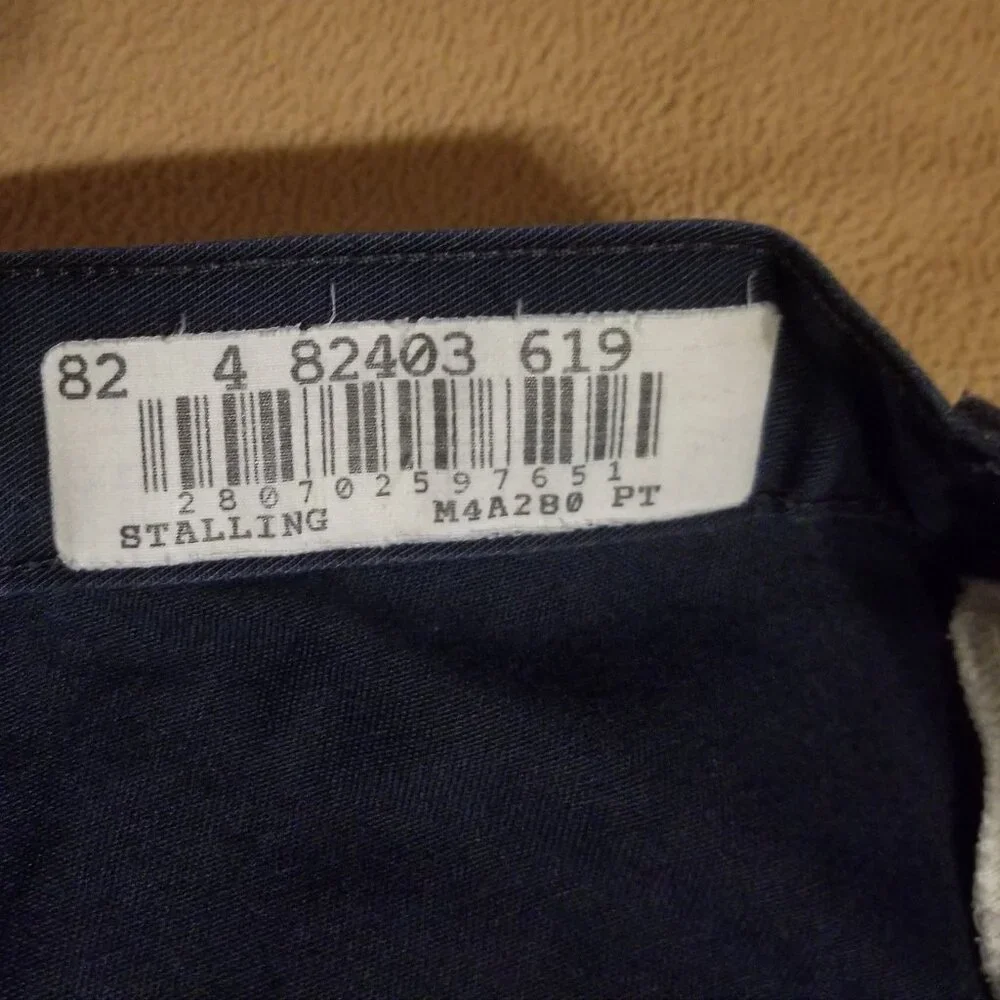 Three stained Cintas men's pants with stretching waistbands